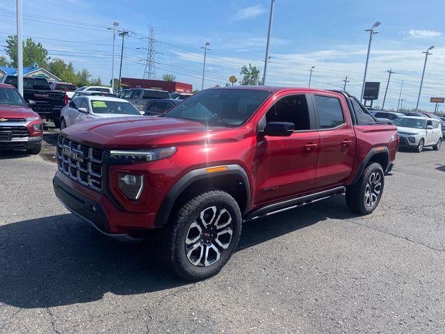 2026 GMC Canyon AT4 in Volcanic Red Tintcoat — front three-quarter view
